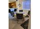 Cozy dining area with round table, four chairs, and natural light from a window at 7616 Colonial Ct, Tampa, FL 33615