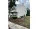 View of the townhome highlighting the siding and backyard landscaping at 7616 Colonial Ct, Tampa, FL 33615
