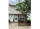 Charming two-story townhome with brick accents and a well-manicured front yard at 7616 Colonial Ct, Tampa, FL 33615