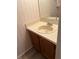 Cozy half-bathroom featuring a vanity and decorative wallpaper at 7616 Colonial Ct, Tampa, FL 33615