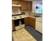 Functional kitchen featuring a range, dishwasher, and wood cabinetry at 7616 Colonial Ct, Tampa, FL 33615