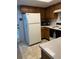 Practical kitchen layout with full-size refrigerator and essential appliances at 7616 Colonial Ct, Tampa, FL 33615