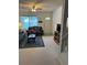 Well-lit living room featuring a sofa, television, and view of the front door at 7616 Colonial Ct, Tampa, FL 33615