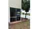 Enclosed patio with a lovely view of the lake and access to outdoor pier at 7616 Colonial Ct, Tampa, FL 33615