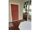 Enclosed porch with brick flooring providing outdoor views and access to backyard at 7616 Colonial Ct, Tampa, FL 33615