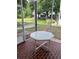 Relaxing screened porch with brick flooring and views of the lush backyard and pond at 7616 Colonial Ct, Tampa, FL 33615