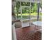 Enjoy serene water views from this screened porch with brick flooring at 7616 Colonial Ct, Tampa, FL 33615