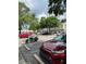 Community parking area with cars parked beneath mature shade trees at 7616 Colonial Ct, Tampa, FL 33615