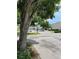 Neighborhood street view with mature trees and well-maintained landscaping at 7616 Colonial Ct, Tampa, FL 33615