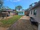 A well-kept backyard featuring a charming gazebo and an additional shed with a patio and fenced perimeter at 7920 52Nd N St, Pinellas Park, FL 33781