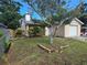 Inviting home exterior featuring a lush lawn, mature tree, and attached garage at 7920 52Nd N St, Pinellas Park, FL 33781