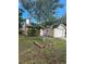Inviting home exterior featuring a lush lawn, mature tree, and attached garage at 7920 52Nd N St, Pinellas Park, FL 33781