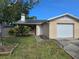 Cozy single-story home featuring a one car garage, well maintained lawn, and charming front landscape at 7920 52Nd N St, Pinellas Park, FL 33781