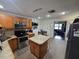 Cozy kitchen with tile flooring, an island, stainless steel appliances and wood cabinets at 7920 52Nd N St, Pinellas Park, FL 33781