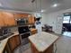 A functional kitchen featuring stainless steel appliances, an island, and ample cabinet space at 7920 52Nd N St, Pinellas Park, FL 33781