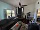 Comfortable living room includes a fireplace, large window, and a ceiling fan for natural light and climate control at 7920 52Nd N St, Pinellas Park, FL 33781