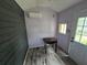 Finished shed with wood walls, laminate flooring, light fixture and a mini-split A/C unit at 7920 52Nd N St, Pinellas Park, FL 33781