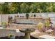 Landscaped backyard featuring a brick waterfall and decorative fountain, surrounded by lush greenery at 941 65Th S St, St Petersburg, FL 33707