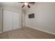 Bedroom with light wood floors, a ceiling fan, a TV, and a double-door closet at 941 65Th S St, St Petersburg, FL 33707