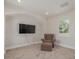 Bonus room featuring a tv mounted on the wall, a large window, and carpeted floor at 941 65Th S St, St Petersburg, FL 33707
