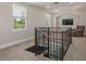 Bonus room featuring neutral carpet, a TV, an armchair, and multiple windows at 941 65Th S St, St Petersburg, FL 33707
