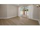 Bright living room featuring light wood floors and sliding glass doors to a fenced brick patio at 941 65Th S St, St Petersburg, FL 33707