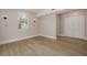 Bright room with light wood floors, a window, and a double-door closet at 941 65Th S St, St Petersburg, FL 33707