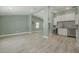 Open-concept living space with wood-look tile flooring and modern finishes creates a bright and airy atmosphere at 941 65Th S St, St Petersburg, FL 33707