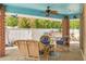 Covered patio with brick columns, light blue ceiling, outdoor seating, and view of the backyard at 941 65Th S St, St Petersburg, FL 33707