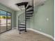 Modern spiral staircase leads to the upper floors with great light from the sliding glass door at 941 65Th S St, St Petersburg, FL 33707