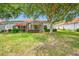 Backyard view showcases a screened-in lanai and lush landscaping, creating a private outdoor space at 10255 Devonshire Lake Dr, Tampa, FL 33647