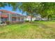 Backyard featuring a screened-in lanai and lush landscaping; perfect for outdoor relaxation and entertaining at 10255 Devonshire Lake Dr, Tampa, FL 33647