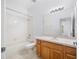 Bright bathroom with a tub/shower combination, single vanity, and a large mirror at 10255 Devonshire Lake Dr, Tampa, FL 33647