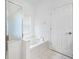 Bathroom with tiled floors, soaking tub, and enclosed shower at 10255 Devonshire Lake Dr, Tampa, FL 33647