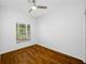 Bright bedroom with hardwood floors and natural light from a large window at 10255 Devonshire Lake Dr, Tampa, FL 33647