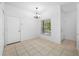 Open dining area featuring tiled flooring, a hanging light, and large window at 10255 Devonshire Lake Dr, Tampa, FL 33647
