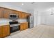 Spacious kitchen featuring stainless steel appliances, tile floors, and plenty of storage at 10255 Devonshire Lake Dr, Tampa, FL 33647