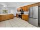 Bright kitchen featuring stainless steel appliances, tile floors, and wooden cabinets at 10255 Devonshire Lake Dr, Tampa, FL 33647