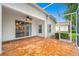 Screened-in lanai with tile floor and ceiling fan connects indoor/outdoor living at 10255 Devonshire Lake Dr, Tampa, FL 33647