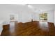 Open-concept living room with wood flooring, bright lighting, and screened-in patio access at 10255 Devonshire Lake Dr, Tampa, FL 33647