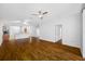 Spacious living room with wood floors and an open layout to the kitchen at 10255 Devonshire Lake Dr, Tampa, FL 33647