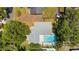 An aerial view of a home's backyard and pool area showcasing landscaping and neighborhood at 11110 105Th Ave, Largo, FL 33778