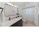 Clean bathroom featuring black vanity, sleek fixtures, modern mirror, and tiled shower at 11110 105Th Ave, Largo, FL 33778
