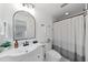 Bright bathroom featuring white vanity, sleek fixtures, modern mirror, and tiled shower at 11110 105Th Ave, Largo, FL 33778