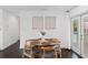Bright dining room with dark wood floors, modern decor, and sliding glass doors at 11110 105Th Ave, Largo, FL 33778