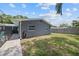 Exterior view of the home showing the yard and the screened-in lanai with access from the house at 11110 105Th Ave, Largo, FL 33778