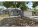 Charming single-story home with a gray brick exterior and a well-maintained two-car garage at 11110 105Th Ave, Largo, FL 33778