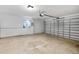 Spacious garage with overhead door, ample lighting, and a functional, utilitarian aesthetic at 11110 105Th Ave, Largo, FL 33778