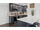 Kitchen boasts modern stainless steel appliances, quartz counters, and dark cabinets at 11110 105Th Ave, Largo, FL 33778