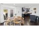 Bright eat-in kitchen features dark cabinets, stainless appliances, and wood floors at 11110 105Th Ave, Largo, FL 33778